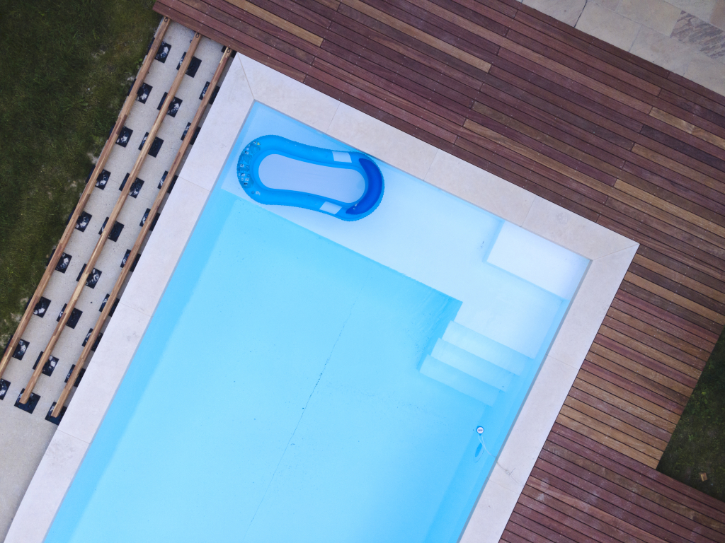 drone-flight-beautiful-green-garden-with-pool-wooden-terrace-pool-is-currently-progress.jpg